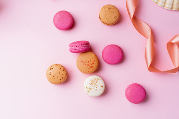 Flatlay with colorful macarons on pink background. Top view