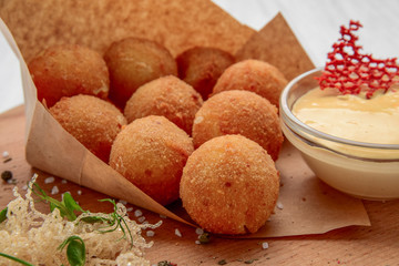 Fried Mac and Cheese balls served with ketch up, selective focus