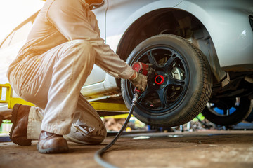Automotive technicians repair the tires or take off the wheels.