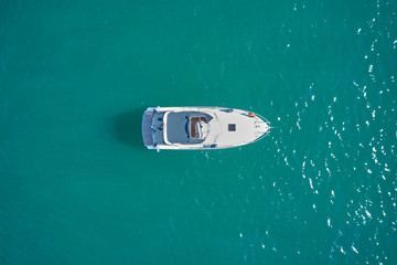 white yacht on blue water top view