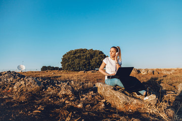 Young woman with her laptop listened external communications