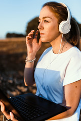 Young woman with her laptop listened external communications
