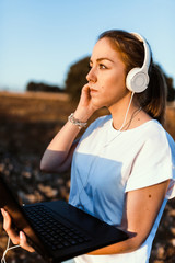 Young woman with her laptop listened external communications