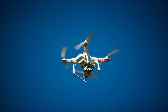 Flight of the drone against the blue sky on a sunny day