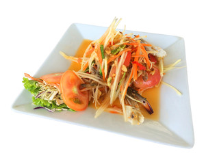 Thai spicy papaya crab salad, Papaya salad spicy on white plate, Thai call Somtam, Very famous food in Thailand, Thai food with herbs and spices ingredients, isolated on white background.