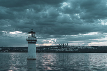 Naklejka premium Lighthouse and Sunset on a lake with clouds, landscape in Leon Mexico.
