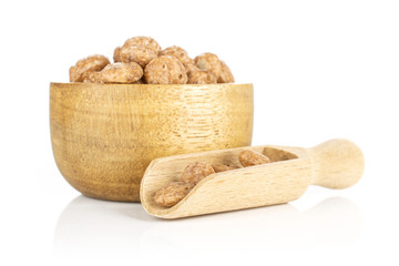 Lot of whole chocolate ball breakfast cereals in wooden bowl with wooden scoop isolated on white background