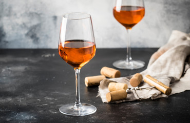 Orange wine in big wine glass, fashionable modern drink, gray counter background, copy space, selective focus