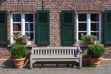 Fototapeta na wymiar Old German house with windows with wooden shutters