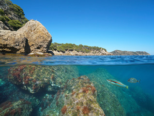 Wild rocky coast in Spain on the Costa Brava, Mediterranean sea, split view over and under water surface, Roses, Cap de Creus, Catalonia