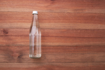 glass water bottle on a wooden table