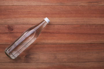 glass water bottle on a wooden table