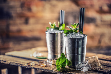 Mint julep cocktail alcoholic drink on wooden board in pub or restaurant - obrazy, fototapety, plakaty