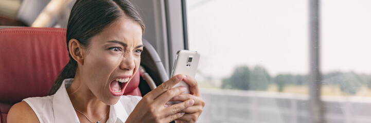 Angry crazy Asian woman upset at mobile phone problem not working or texting upset to somebody over...