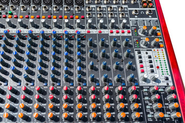 Close up photo of a professional sound mixer with many adjustments, knob switches and buttons of...