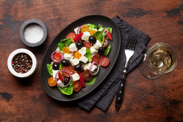Greek salad plate and white wine