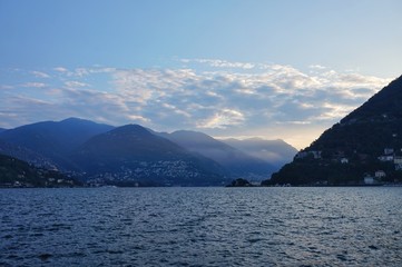 Obraz na płótnie Canvas The sun rises over the Alps and Lake Como. View from the promenade of Como.