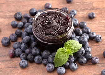 AJar of Homemade Blueberry Jam on a Rustic Wooden Table