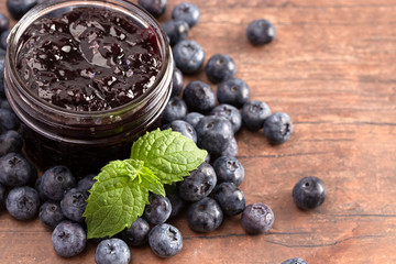 AJar of Homemade Blueberry Jam on a Rustic Wooden Table