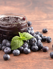 AJar of Homemade Blueberry Jam on a Rustic Wooden Table