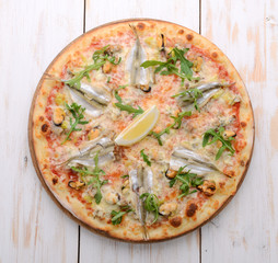 Delicious spicy Italian food, pizza with anchovies and gherkins, hot piquant meals for foodie
