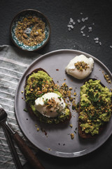 Poached egg on top of the sourdough toast with smashed avocado and dukkah spice