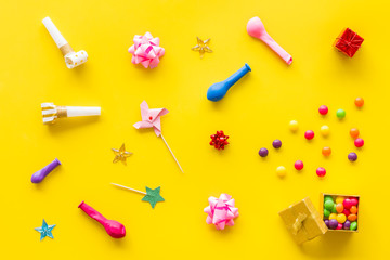 party time pattern with decorations on yellow background top view