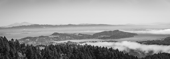 Mountains with fog rolling in over in black and white