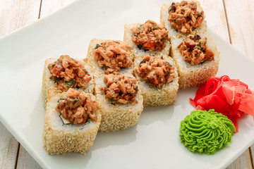 Japanese sushi roll topped with spicy salmon slice