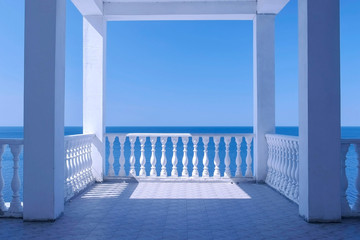 Beautiful terrace with decorative fence made of concrete and amazing sea view at sunny day.