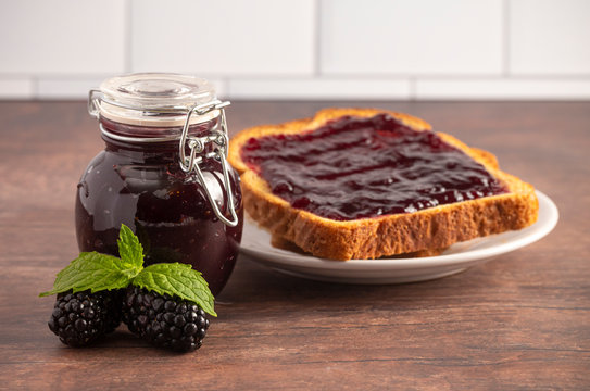 Jar of Homemade Blackberry Jam on a Rustic Wooden Table