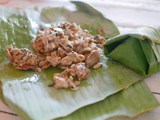 Close up of fermented sour mushrooms, a rare seasonal Northern Thai menu, ( Hed Som ) in a banana leaf