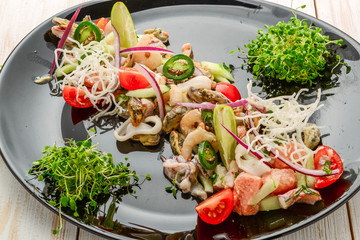 Thai spicy and sour seafood salad on a wooden table