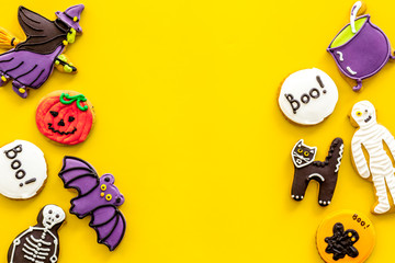 Halloween decorations frame on yellow background top view copyspace