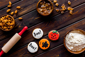 Cook halloween gingerbread cookies on wooden background top view