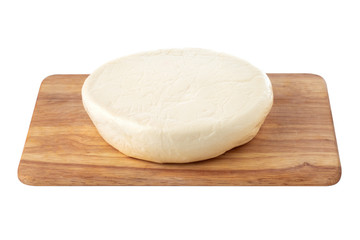 Cheese on a wooden board. Close Up piece of cheese on a white background.