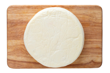 Cheese on a wooden board. Close Up piece of cheese on a white background. Top view.