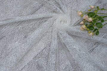 The texture of lace on wooden background decoreted roses.