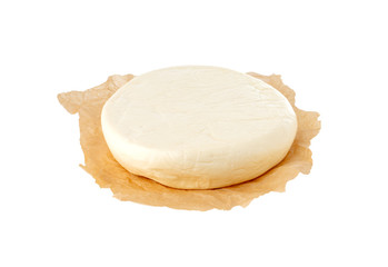 Cheese on parchment paper. Close Up piece of cheese on a white background.