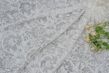 The texture of lace on wooden background decoreted roses.