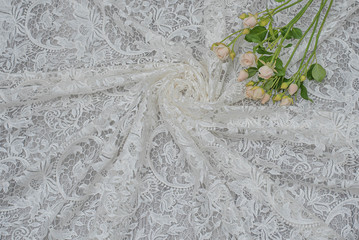 The texture of lace on wooden background decoreted roses.
