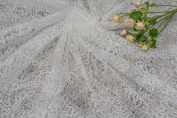 The texture of lace on wooden background decoreted roses.