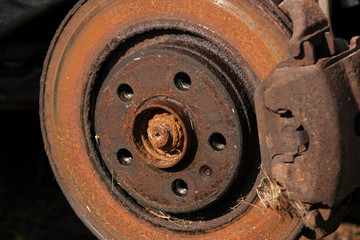 old rusty brake disc on a car close-up