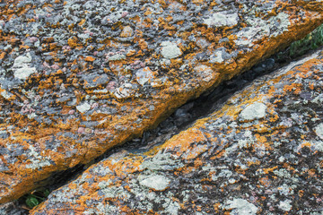 Motley black gray orange stone