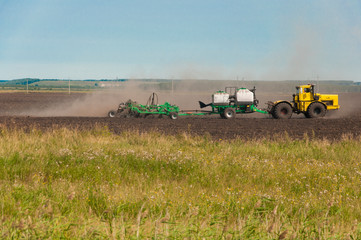 Fototapeta premium Combine-harvester collecting wheat grain. The theme is agriculture.