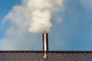 Smoke coming out the chimney against sky