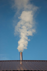 Smoke coming out the chimney against sky