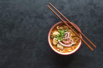 Delicious spicy seafood noodle soup. Top view, copy space