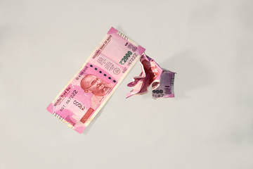 clean & crumpled modern Indian Two Thousand Rupees Currency Notes on a minimal grey background