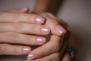 Obraz na płótnie Canvas manicurist uses a manicure nail file to process the nail plate and nail file